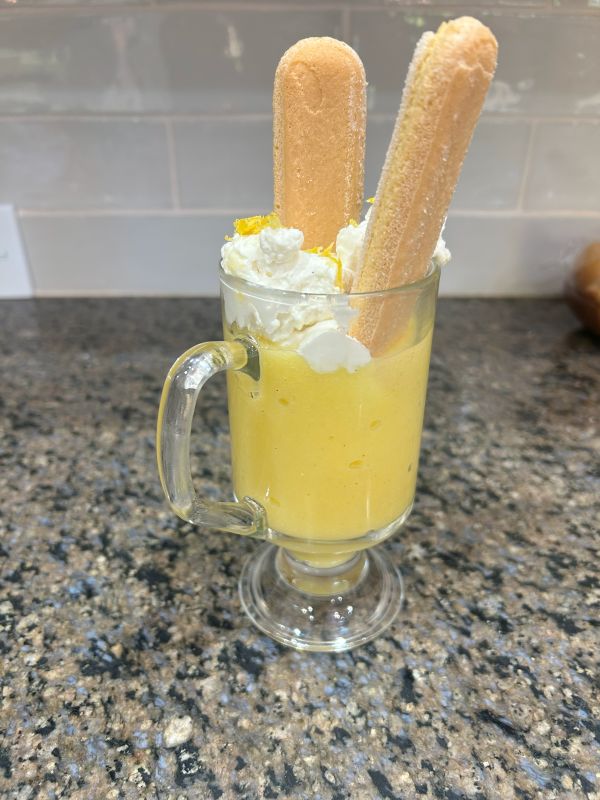 Lemon pudding in a glass with frosting and ladyfingers