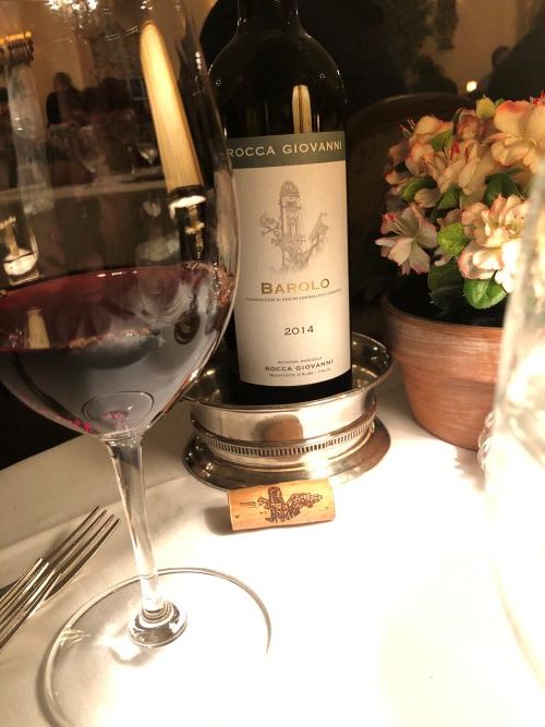 Bottle of wine with a glass on a table