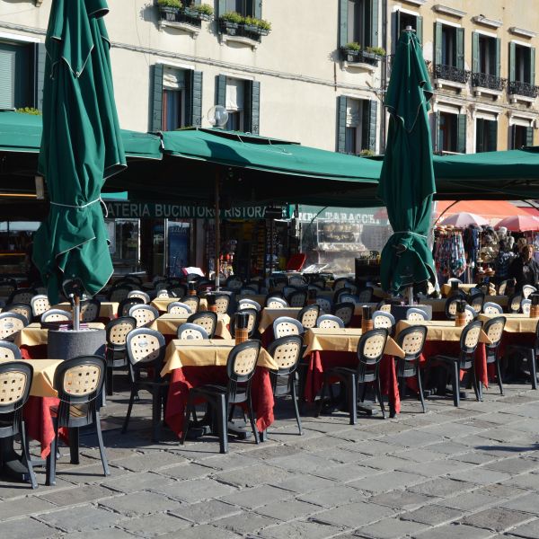 Tables and chairs on a street in Rome
