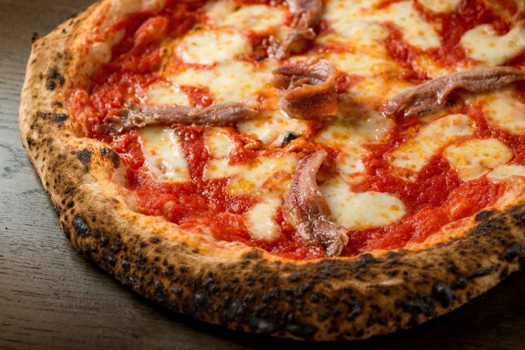 A pizza with anchovy