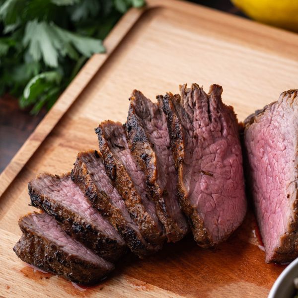 Tri-tip steak sliced on cutting board
